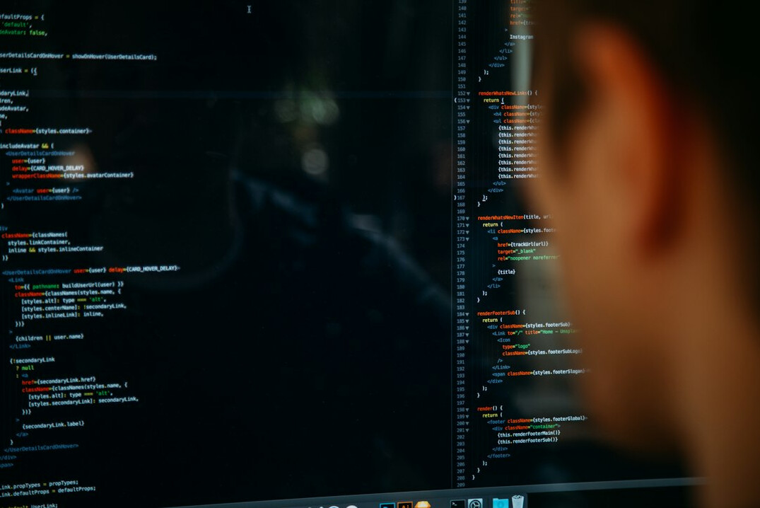 woman reviewing code on screen