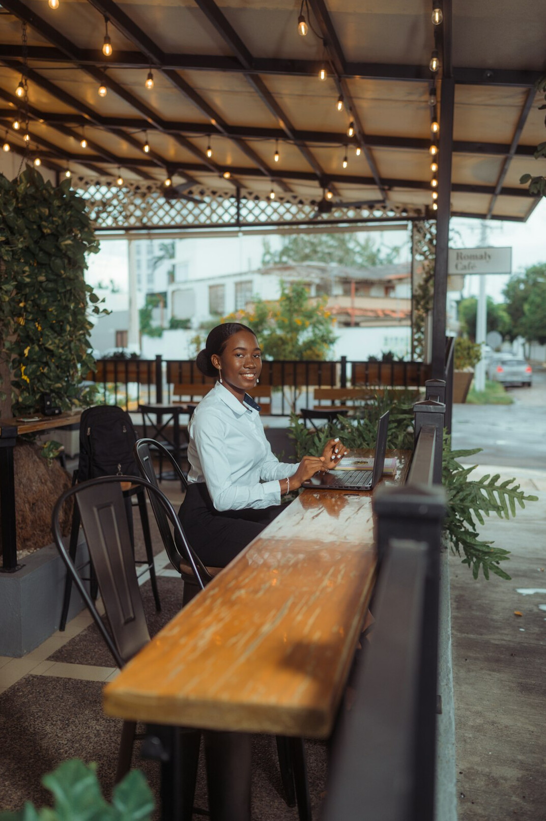 person coding on laptop in cafe