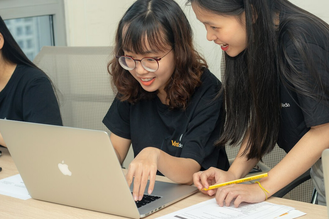 person coding on laptop