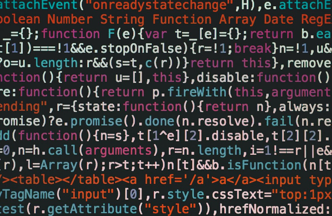 students coding on laptops